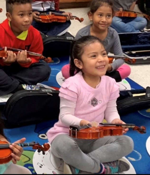 Excited Easton Elementary students receive their real violins for the first time.