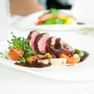 sliced beef roast on microgreens