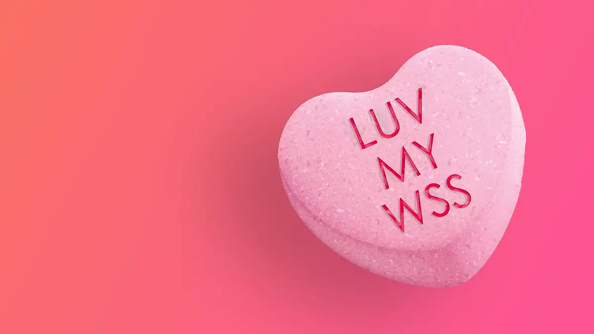 A candy heart that says "LUV MY WSS" on a pink background
