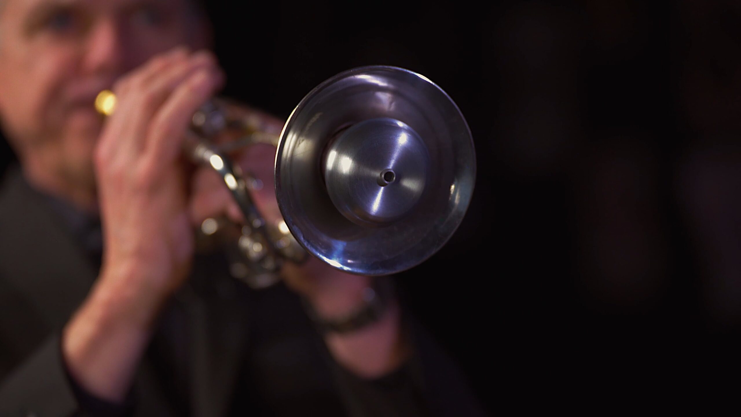 Ken Wilmot playing a muted trumpet